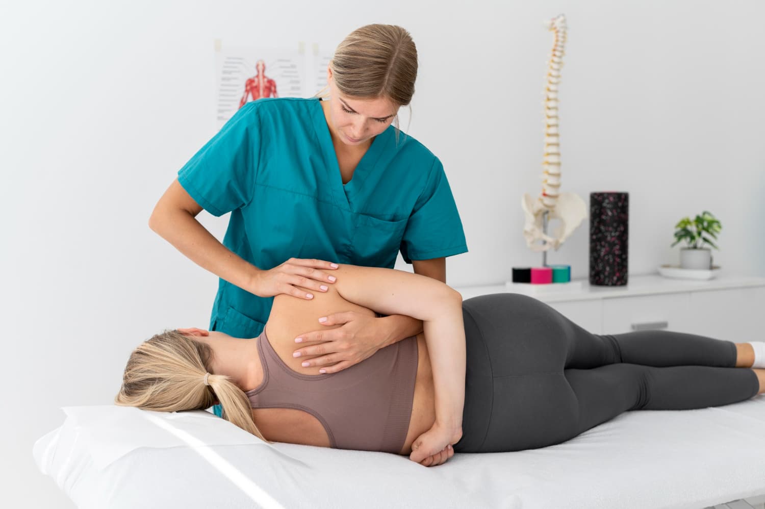 physiotherapist-helping-patient-her-clinic