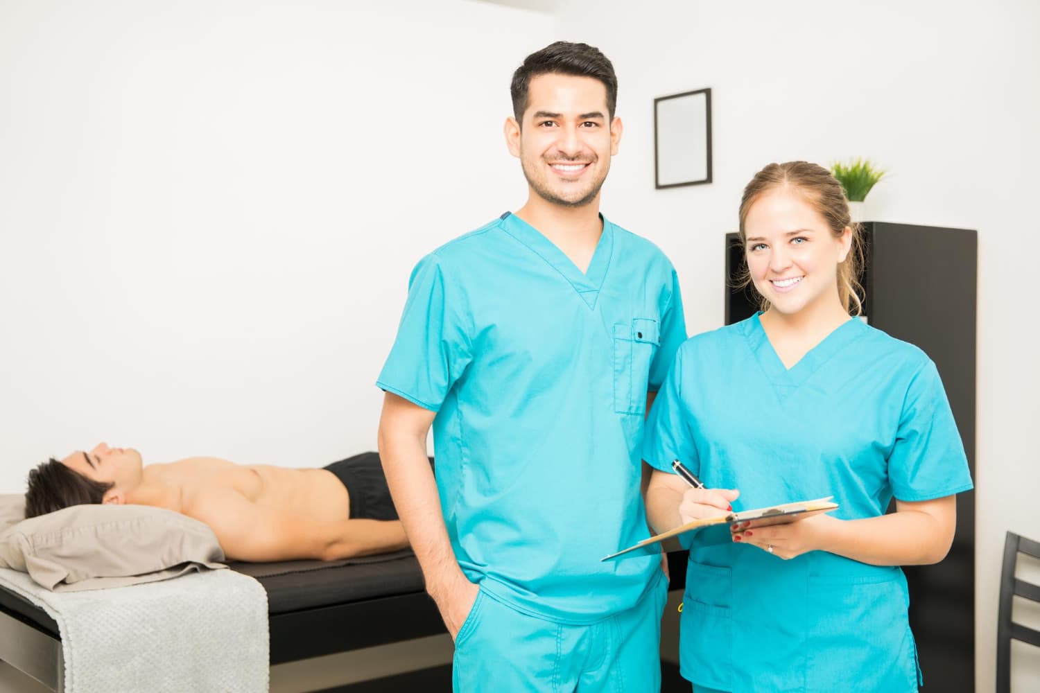 portrait-male-female-physiotherapists-with-clipboard-standing-hospital